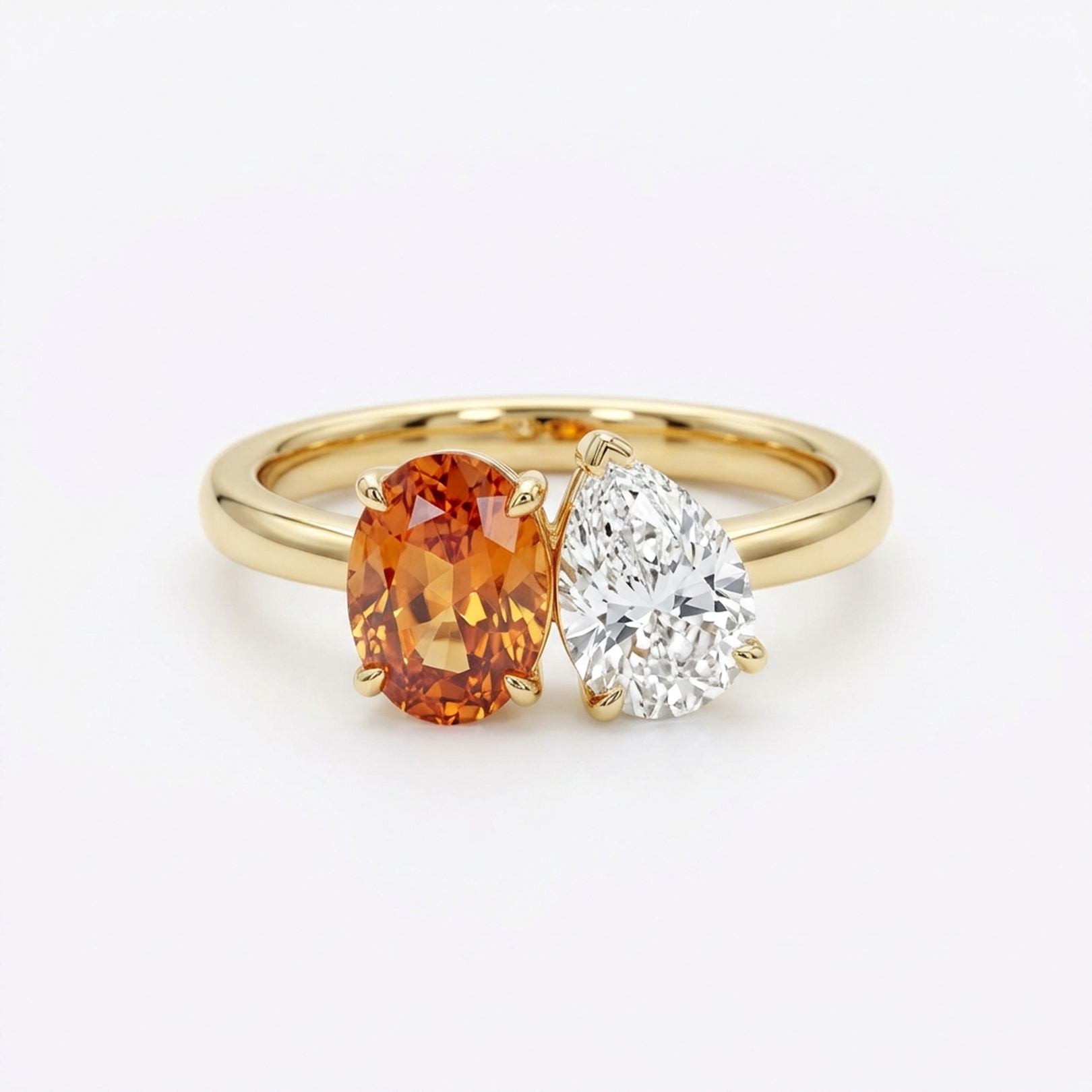 Orange oval gemstone and pear-shaped diamond bypass ring